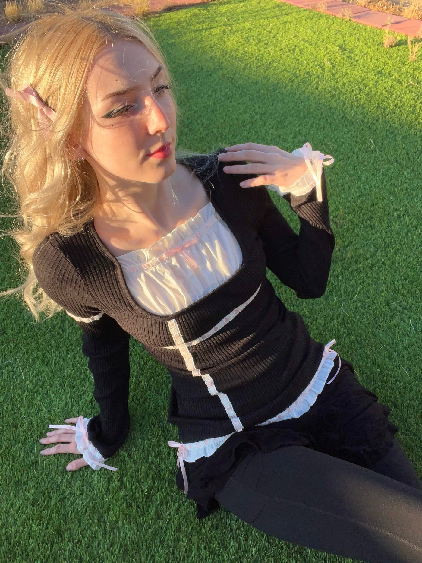 Person wearing the black "johnny" corset blouse outdoors, front view